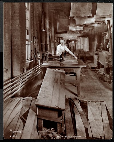 Interior View of a Man Working with Leather at the New York Leather Belting Co., New York by Byron Company